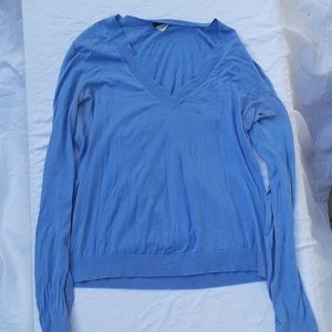 A  baby blue %100 cotton v-neck sweater .